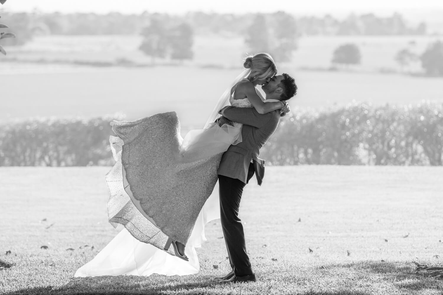 hunter valley wedding photography of black and white photo of andrew lifting ash up