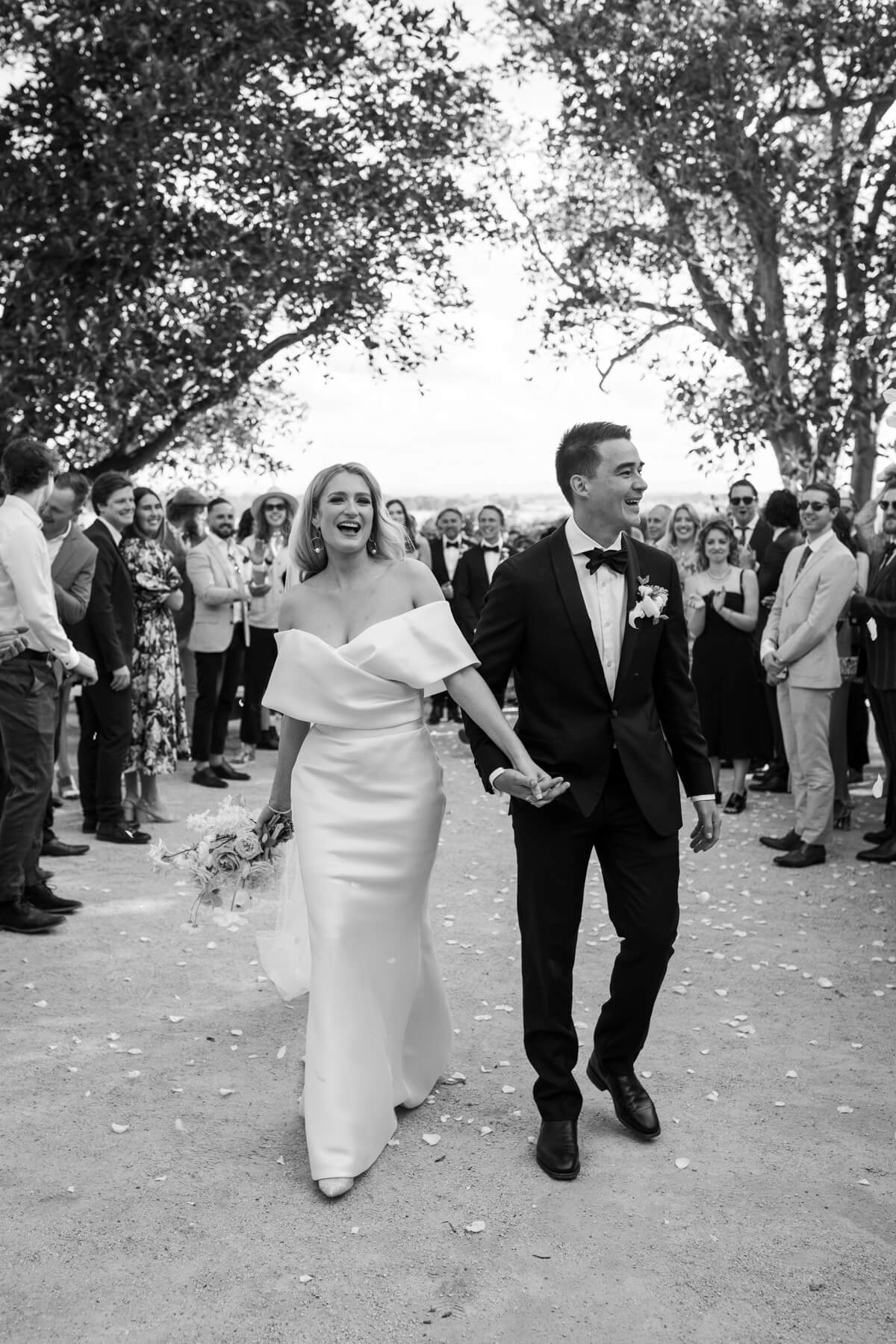 couple walking back down the aisle at their wallalong house wedding