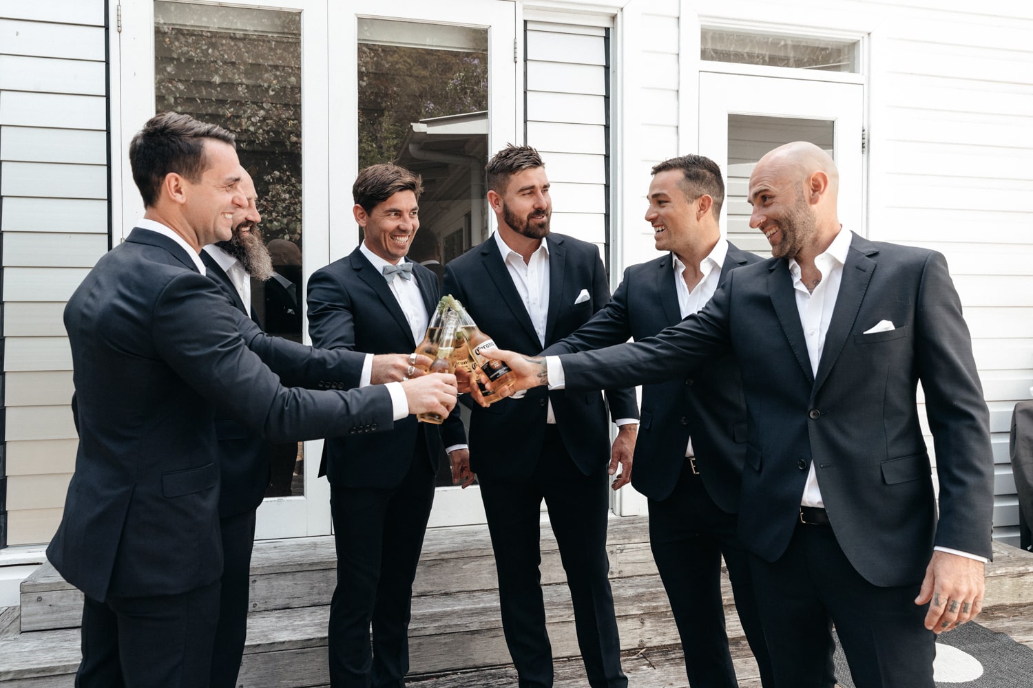 the guys going for a cheers - palm beach wedding
