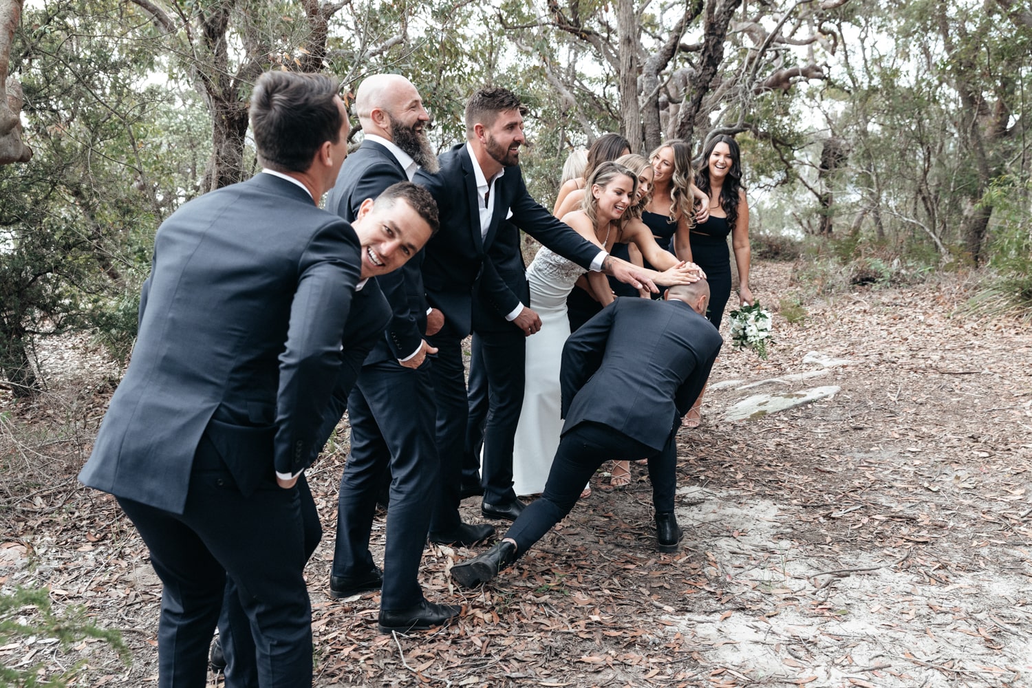 the bridal party touching a balled head - palm beach wedding