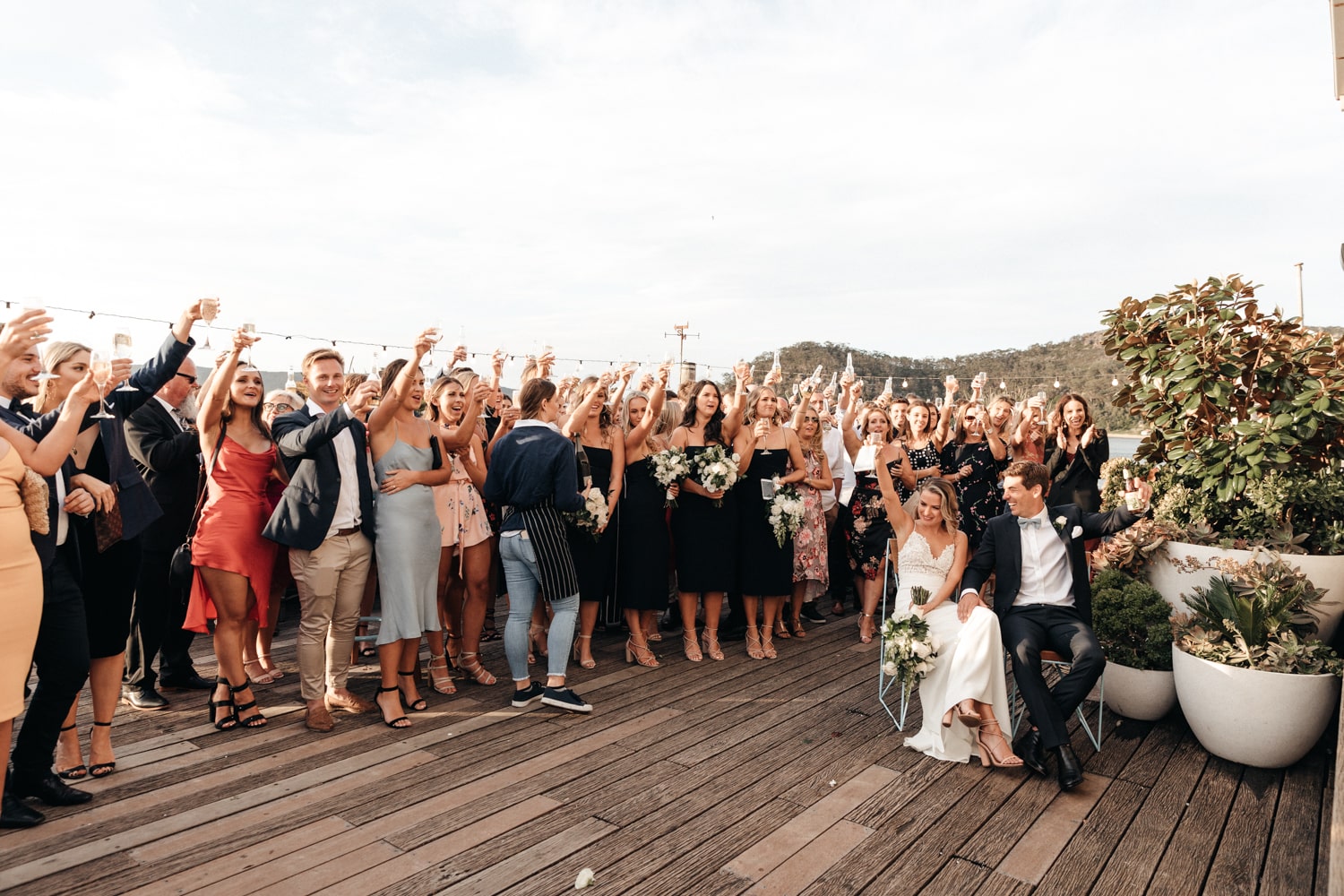 guests raising a glass for a toast - palm beach wedding
