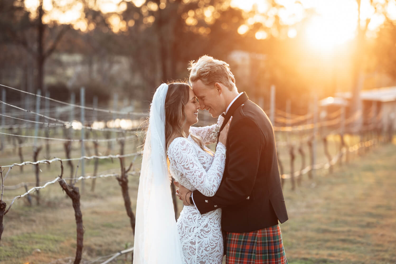 Ashley and Hamish pressing foreheads during their enzo ironbark hill wedding portrait session