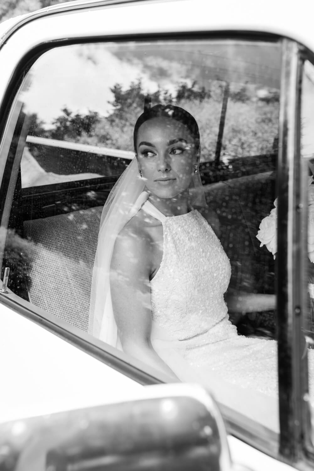 Kelsey look out the window of a car at The Old Coach Stables Wedding