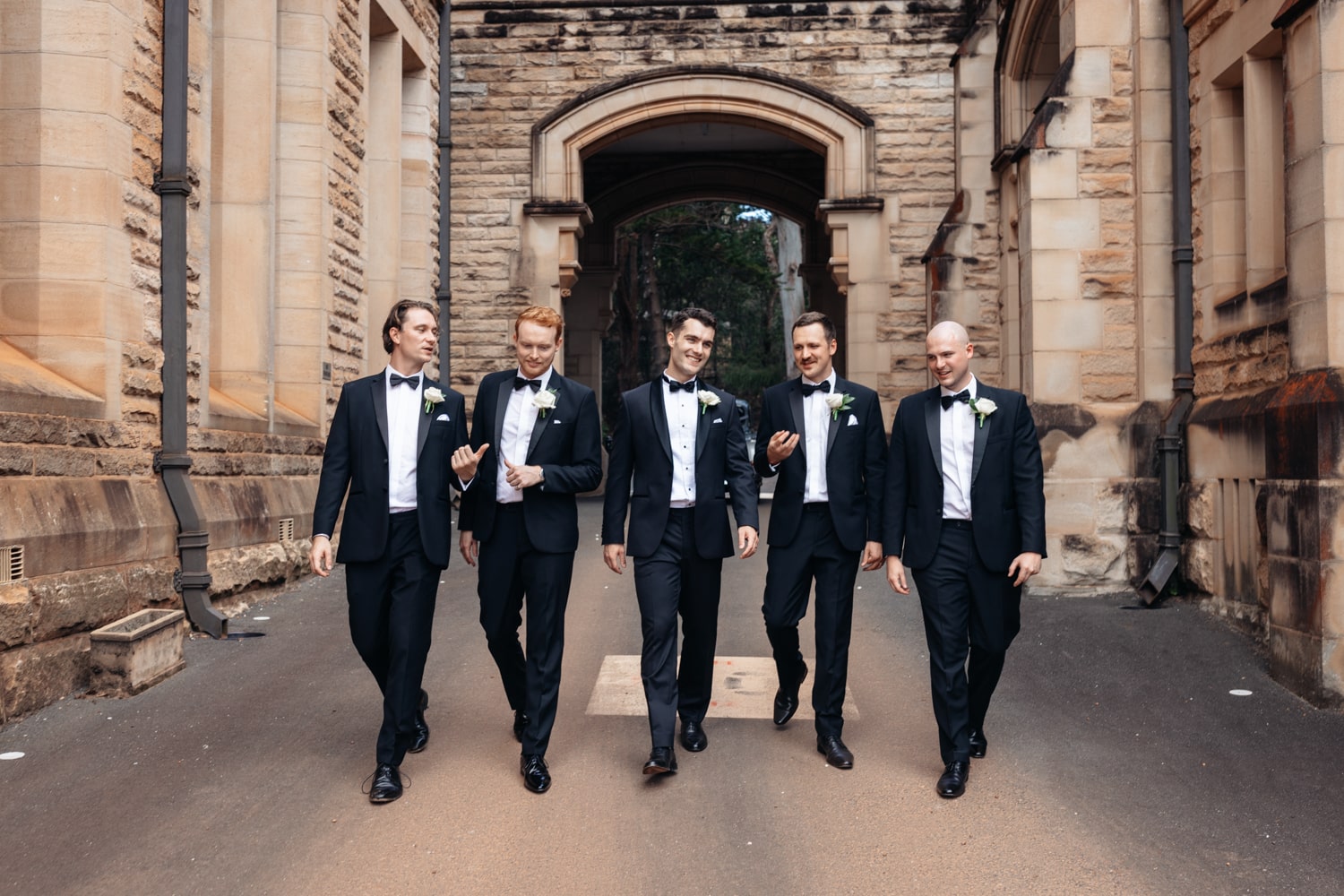 groomsmen walking down a driveway at ICMS manly