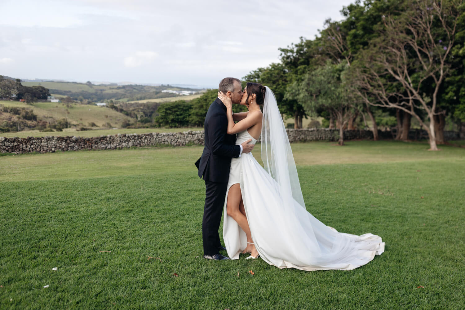 couple on the lawn kissing for their greyleigh kiama wedding