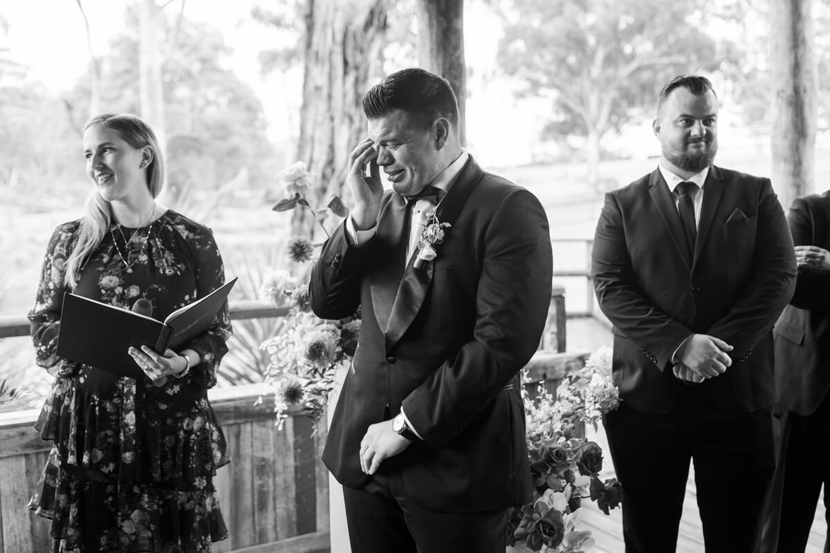 a groom getting emotional on his wedding day as he sees his bride for the first time