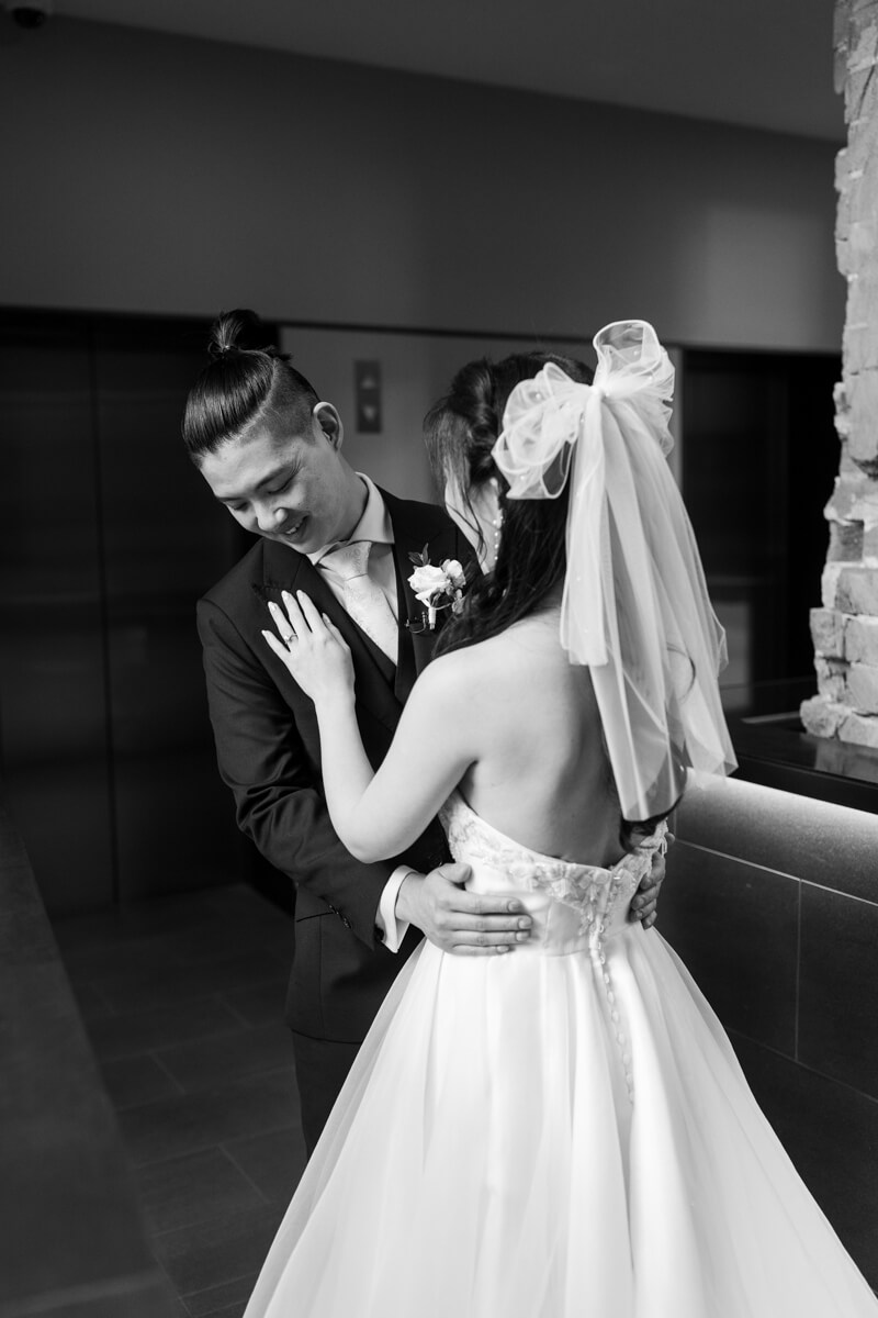 a groom checking out his bride after seeing her for the first time when they did their first look