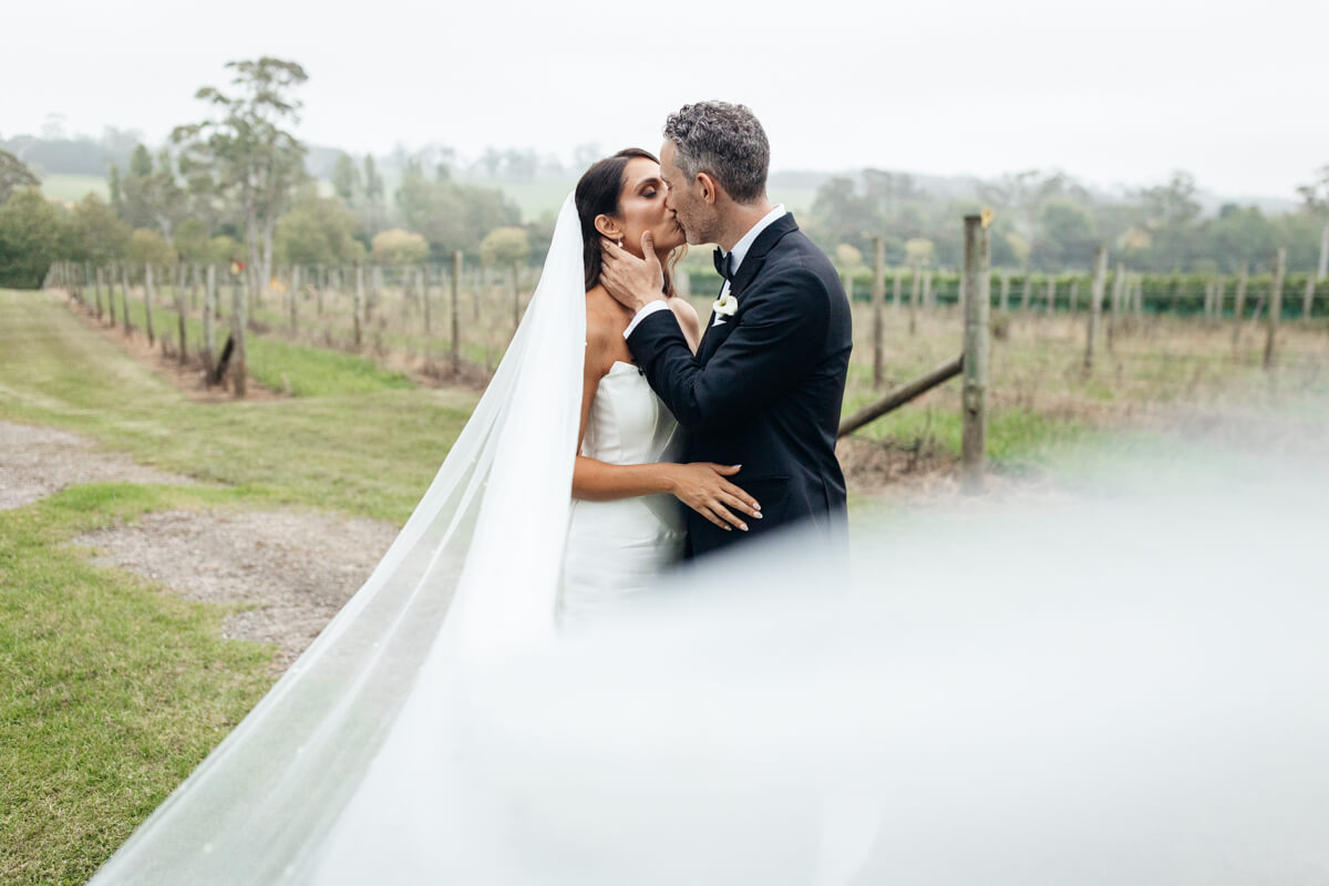 a moment with the bride and groom during their centennial vineyards wedding