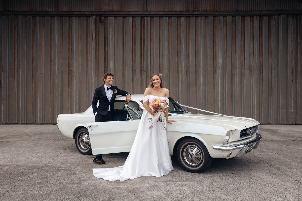 Car photos with the bride and groom during their manly pavilion wedding