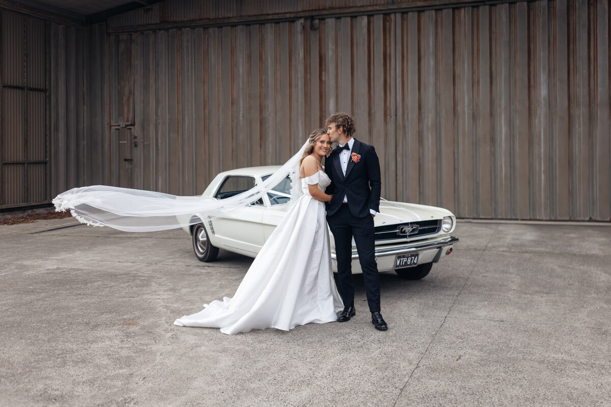 car portraits with the bride and groom nearby manly pavilion for their wedding