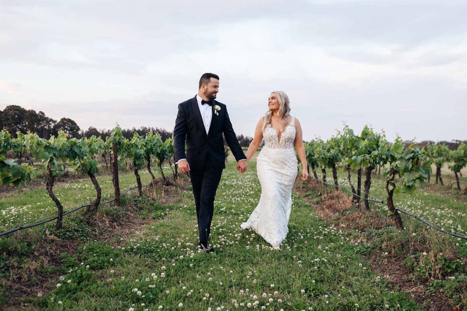 couple in the vines at their peterson house wedding