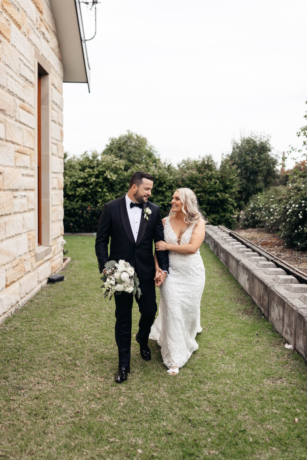 couple walking hand in hand at their peterson house wedding