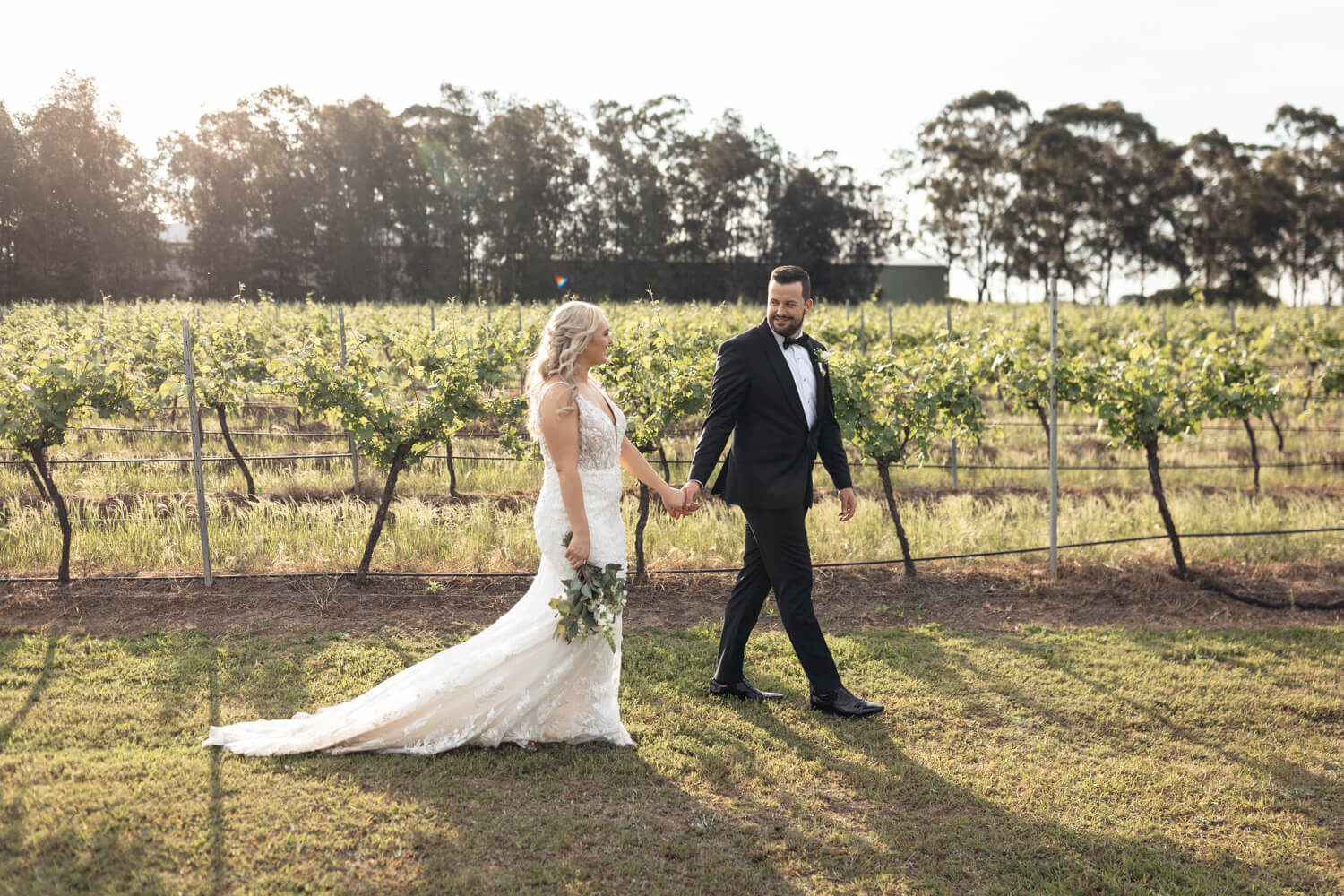 couple walking in front of the vines at their peterson house wedding