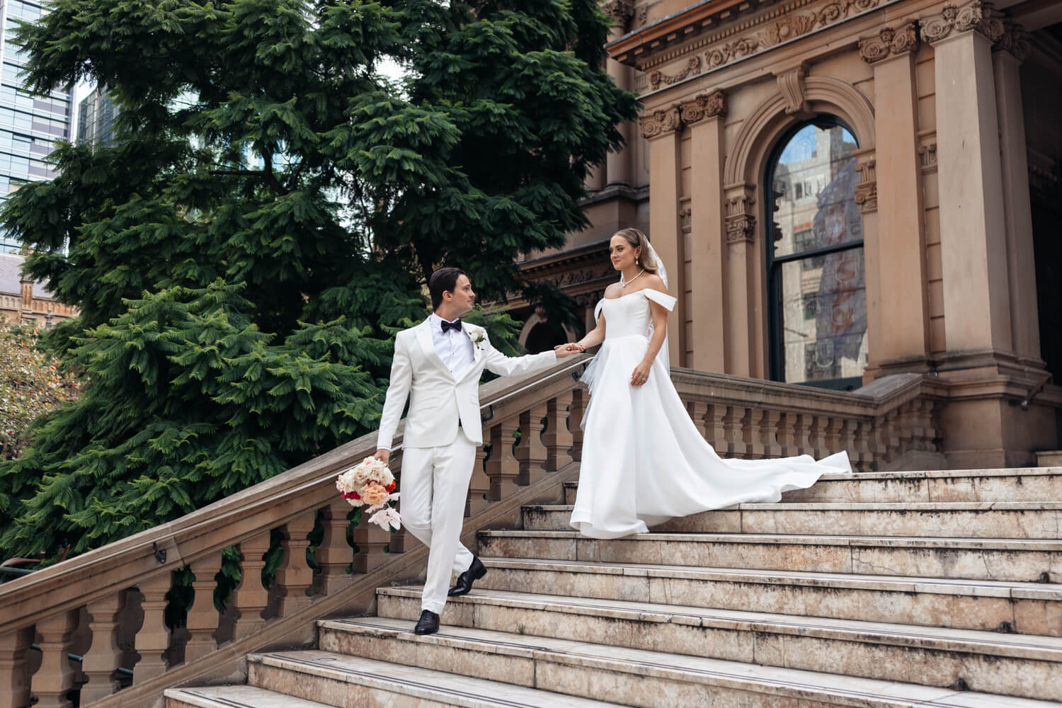 Groom leading the bride down the Town Hall Stairs during their Events By Alpha wedding
