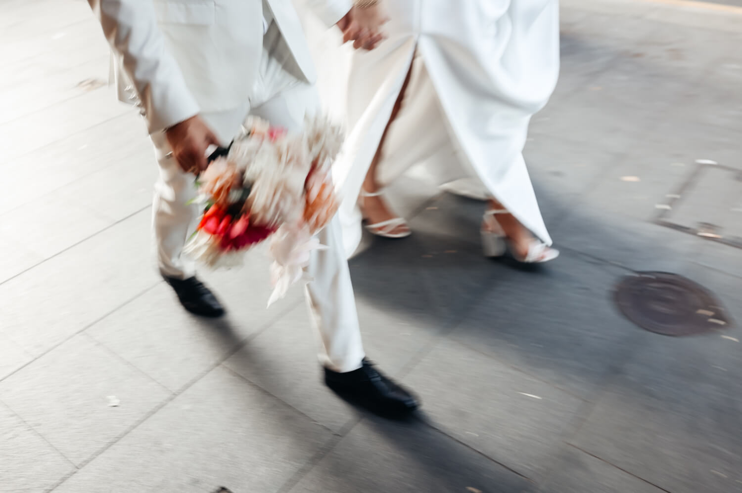 A blurry picture of the bride and grooms feet as they walk back to their Events By Alpha wedding reception