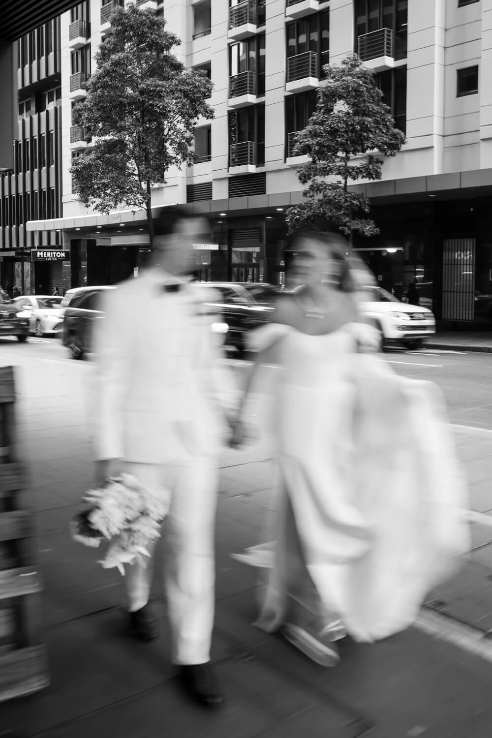A blurry photo of the bride and groom walks back to Events By Alpha