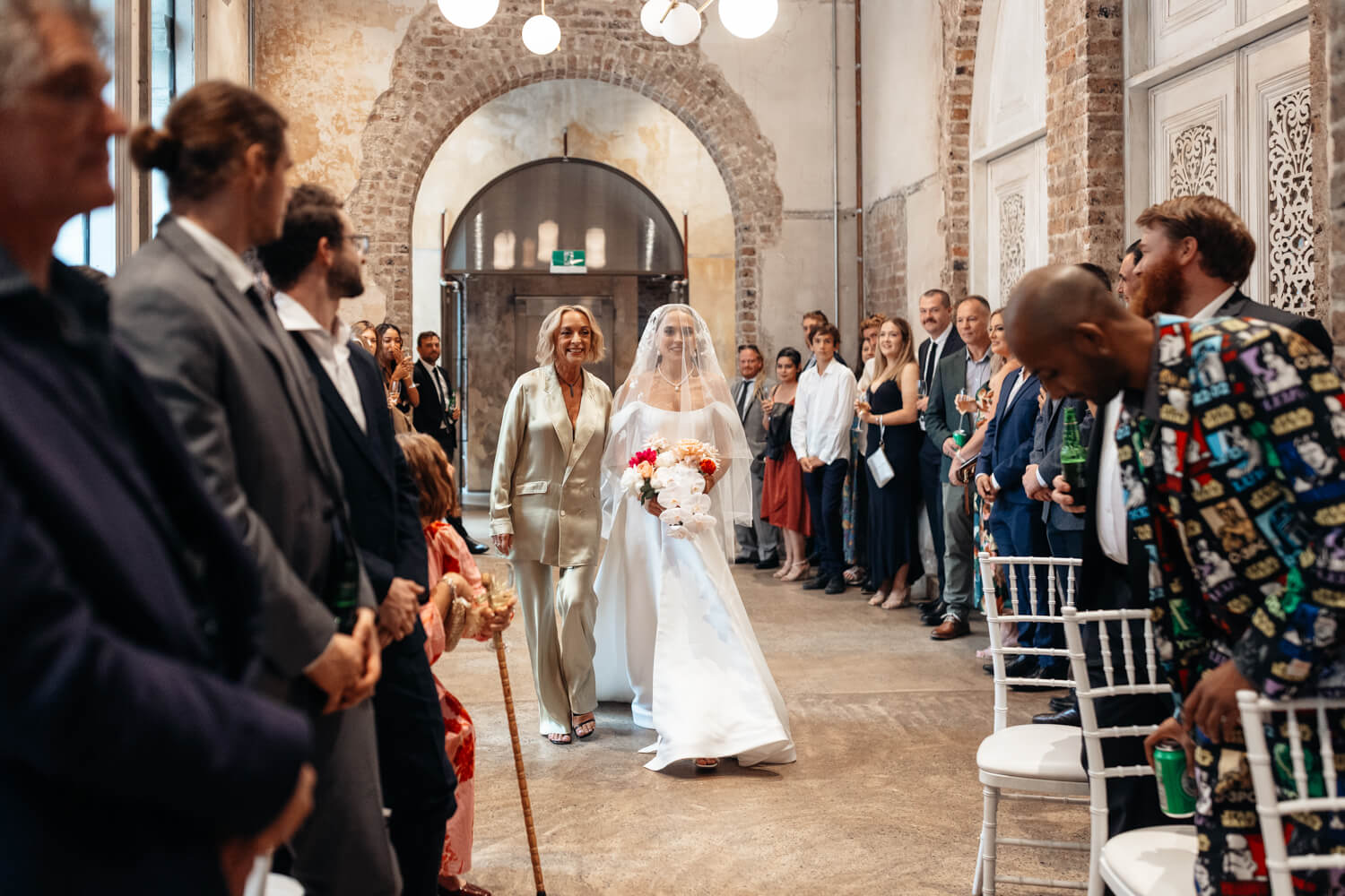 Bride walking down the asile with her mum at her Events By Alpha wedding 