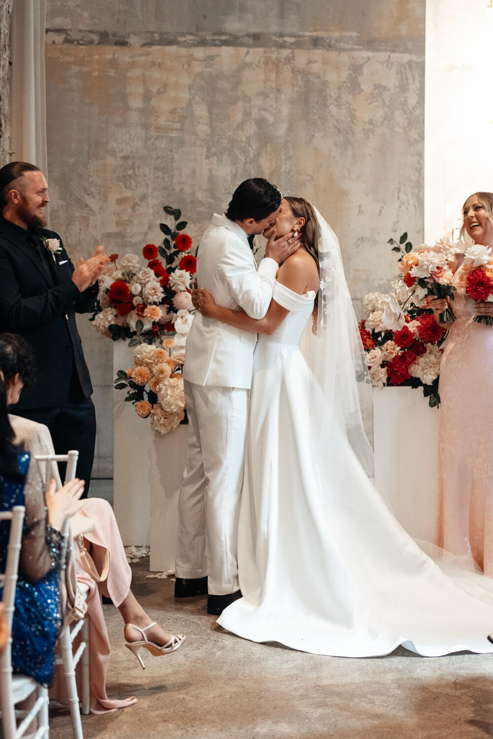 Bride and groom share their first kiss at their Events By Alpha wedding ceremony