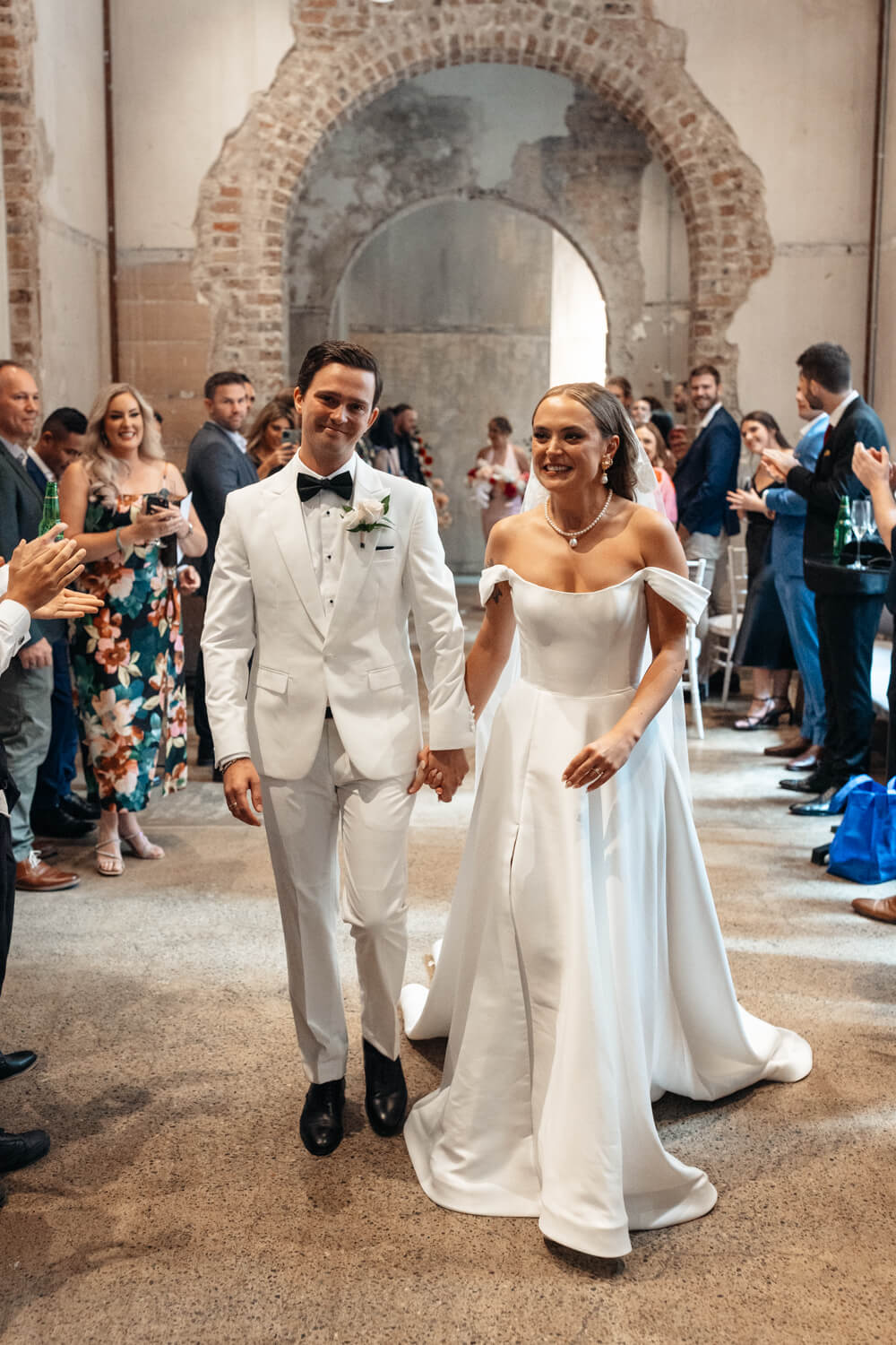 Couple walking out of their Events By Alpha wedding ceremony