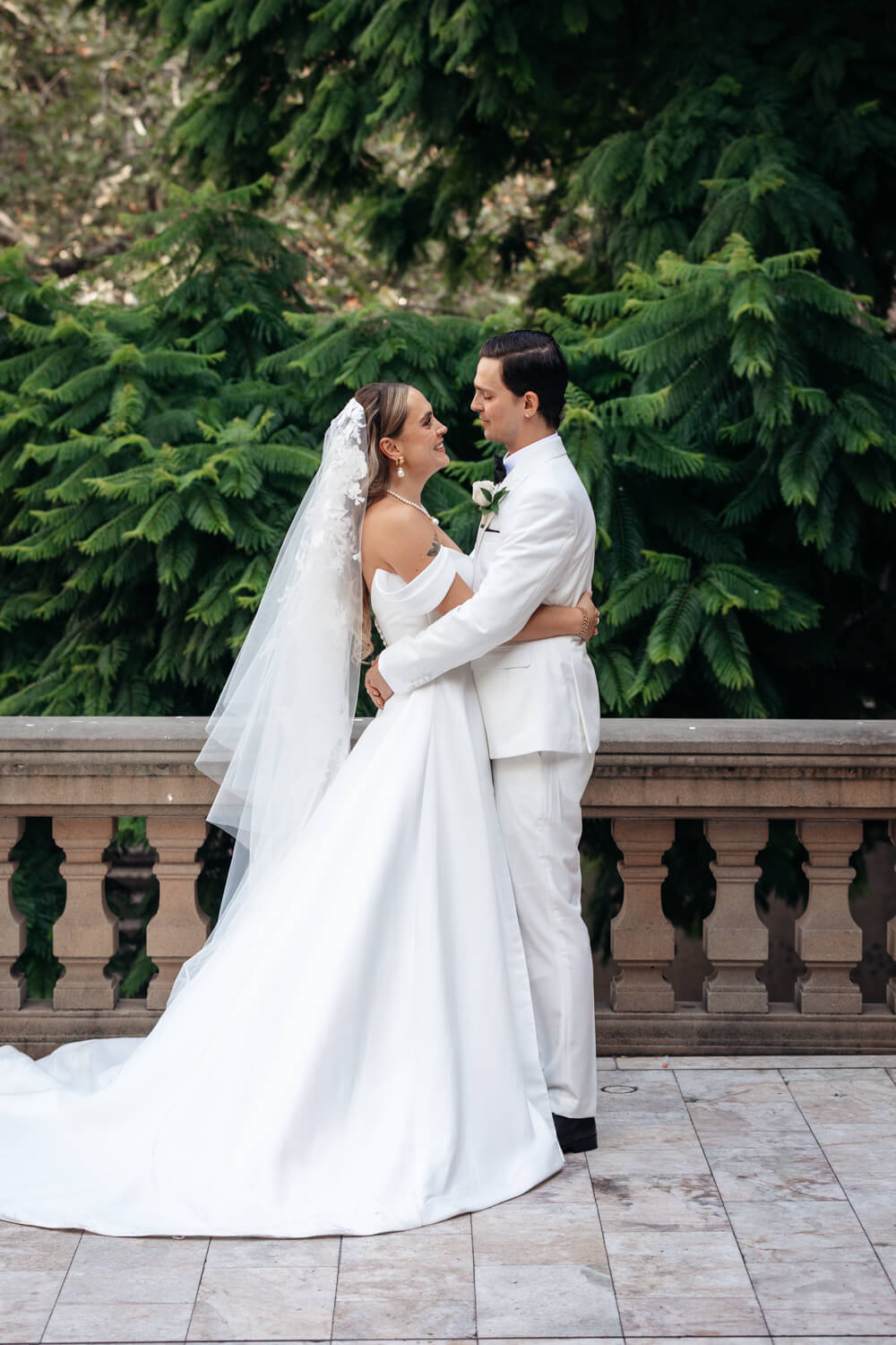 Bride and groom looking at each other during their Events By Alpha wedding outside Town Hall