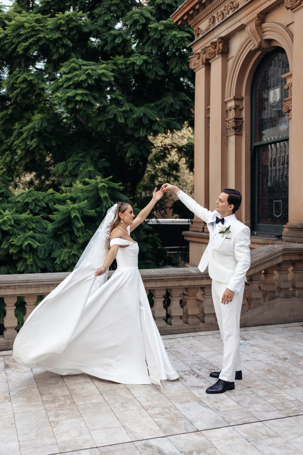 A groom spinning his bride and Town Hall during the Events By Alpha wedding