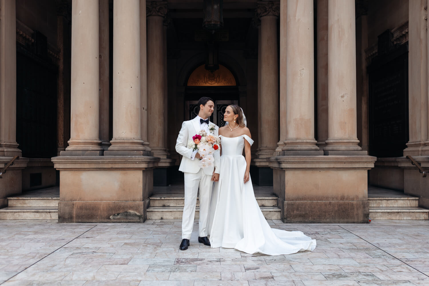 Bride and groom standing infront of the Town Hall entrance