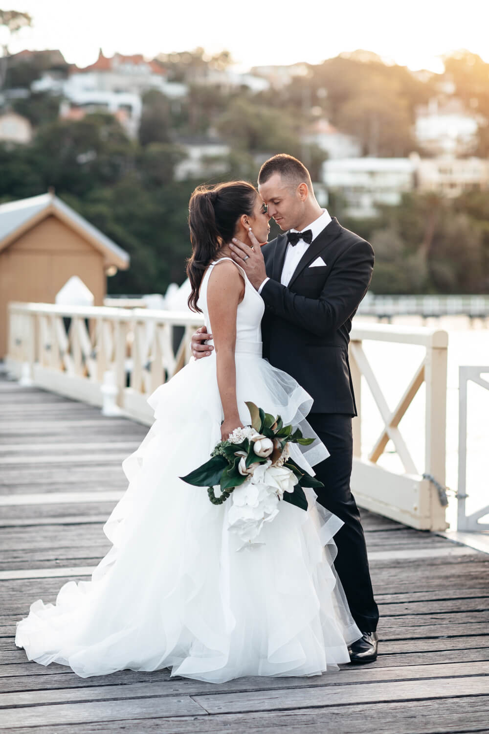 Groom holding his bride at Chowder Bay