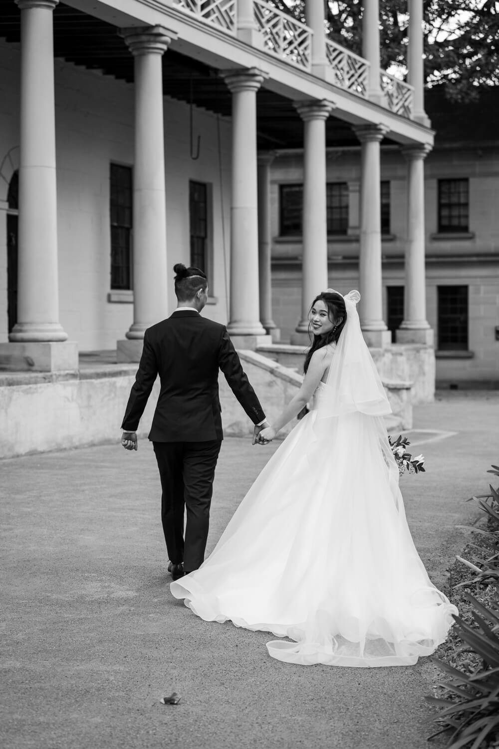 Bride looking over her should during their The Mint wedding