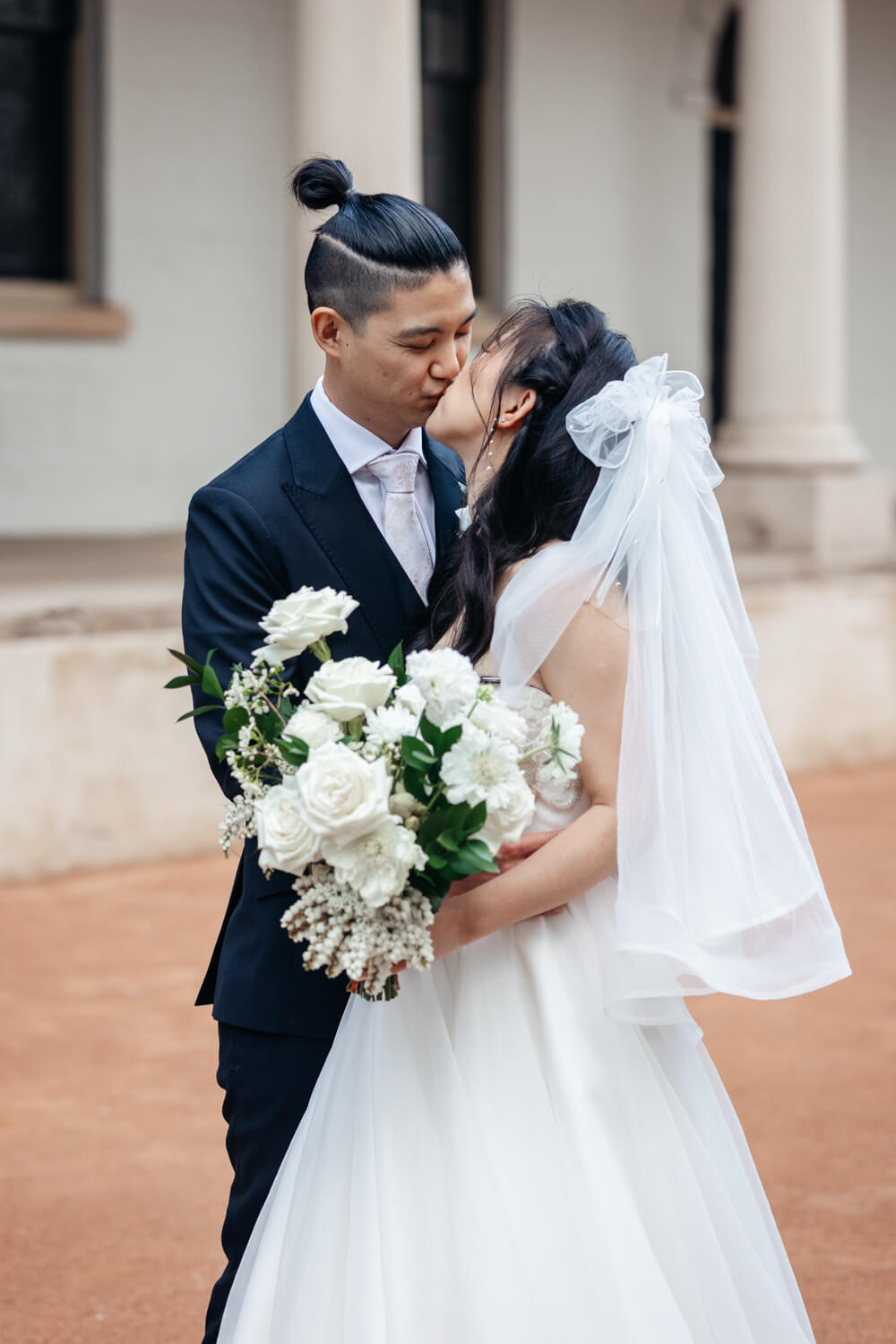 Bride and groom kissing at their Mint wedding