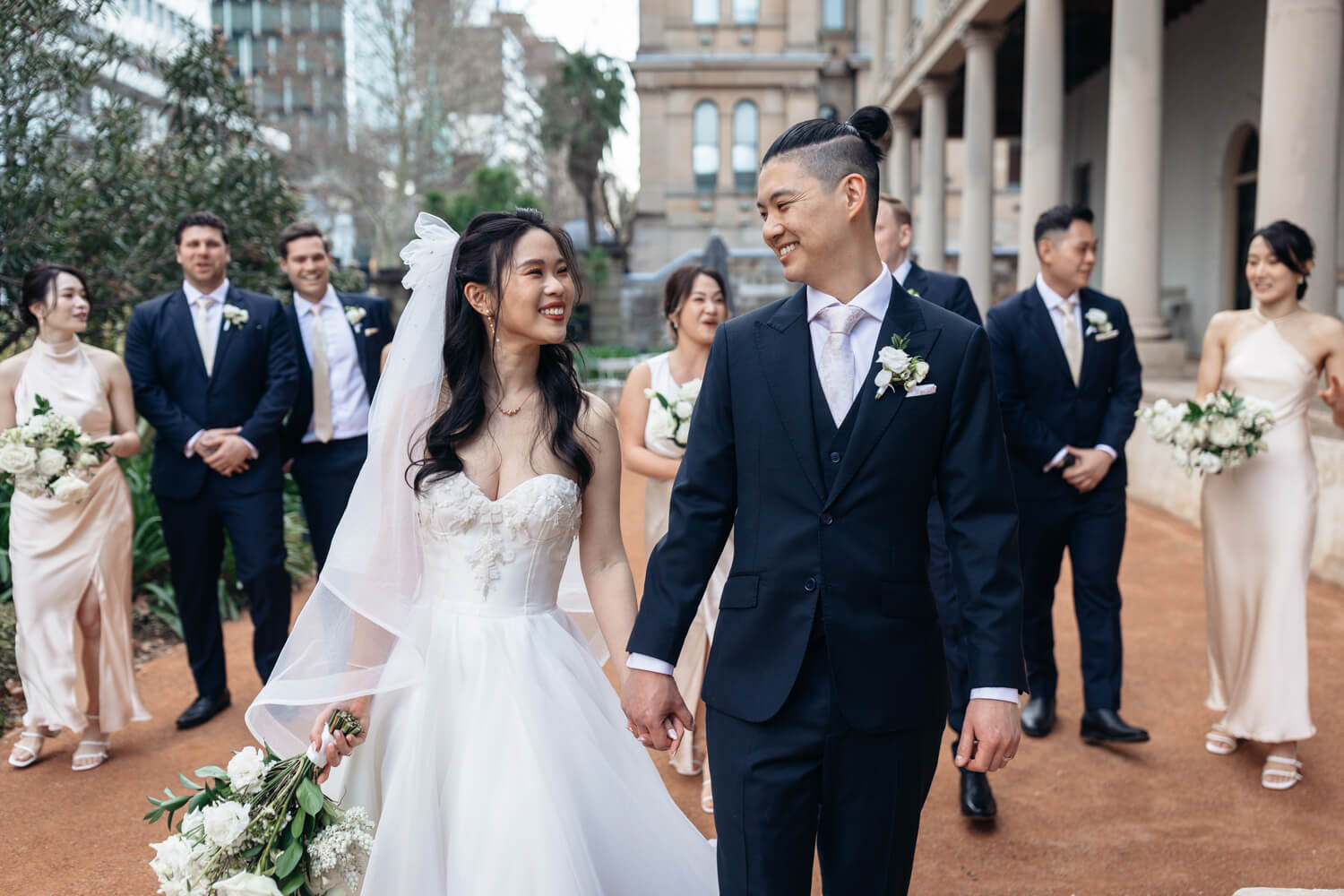 Bride and groom walking hand in hand at The Sydney Mint 