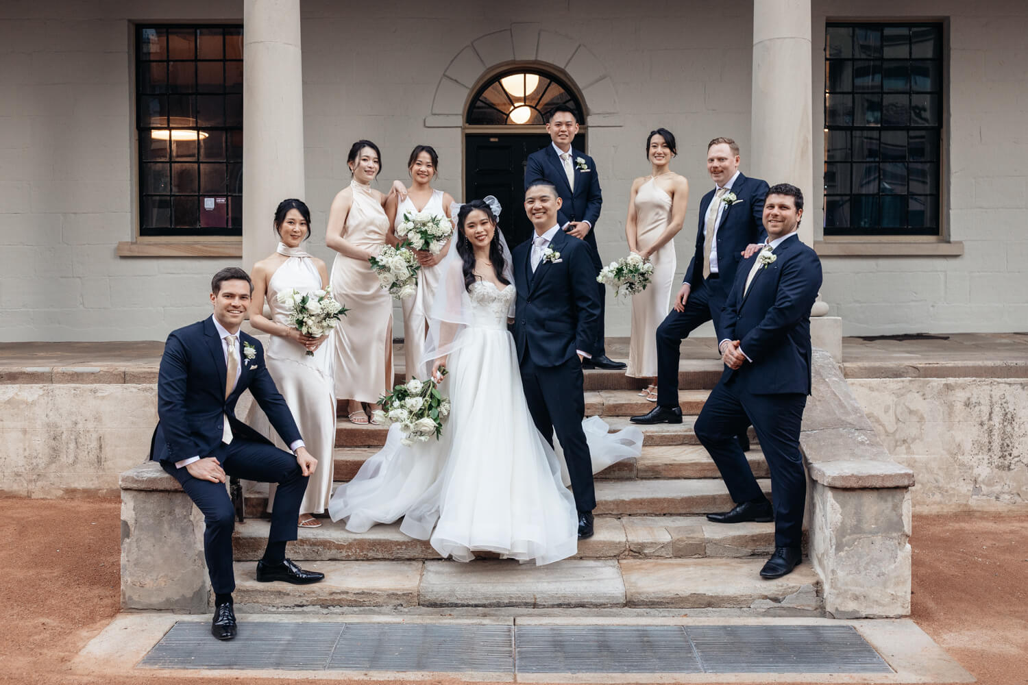 Brindal party standing on the steps for a portrait in front of The Mint during their wedding