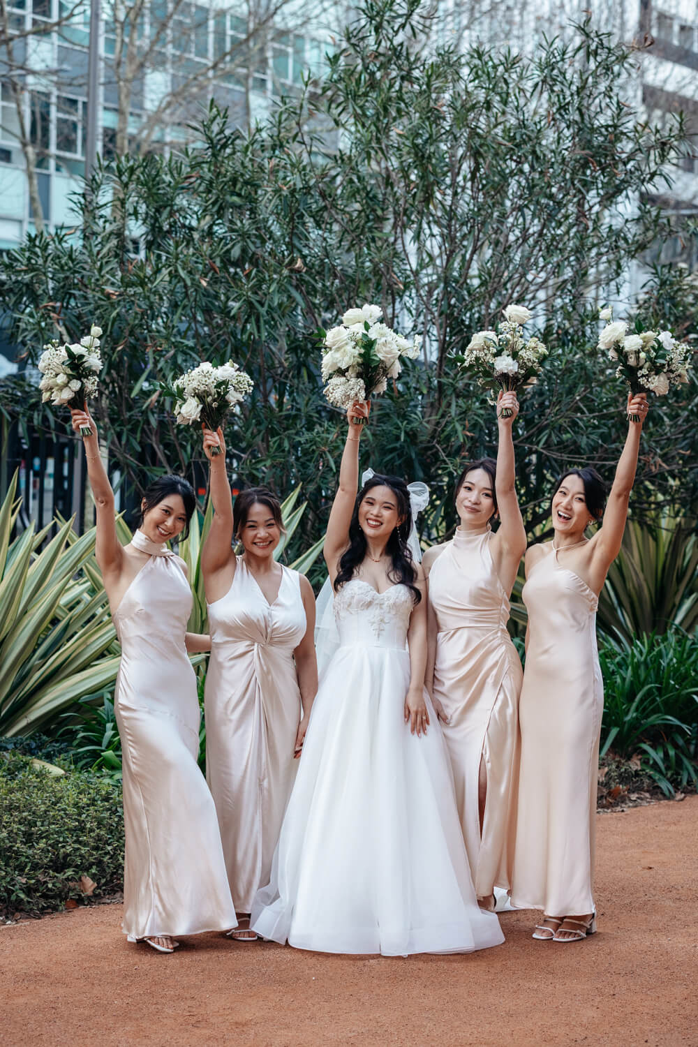 The bridesmaids with flowers in the air at The Mint