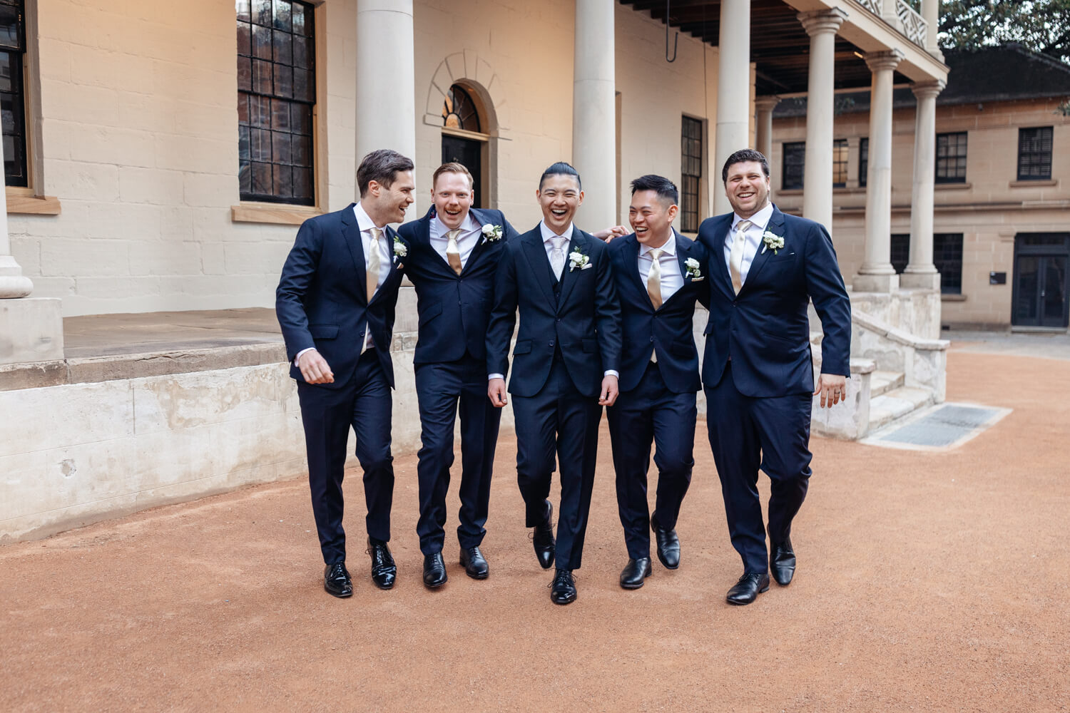 The groomsmen all laughing together during their wedding at The Mint