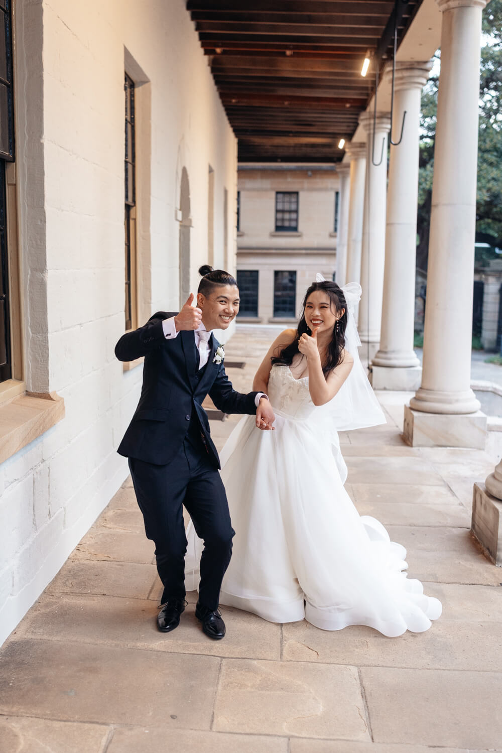 Bride and groom gives the photographer a thumbs up at The Mint