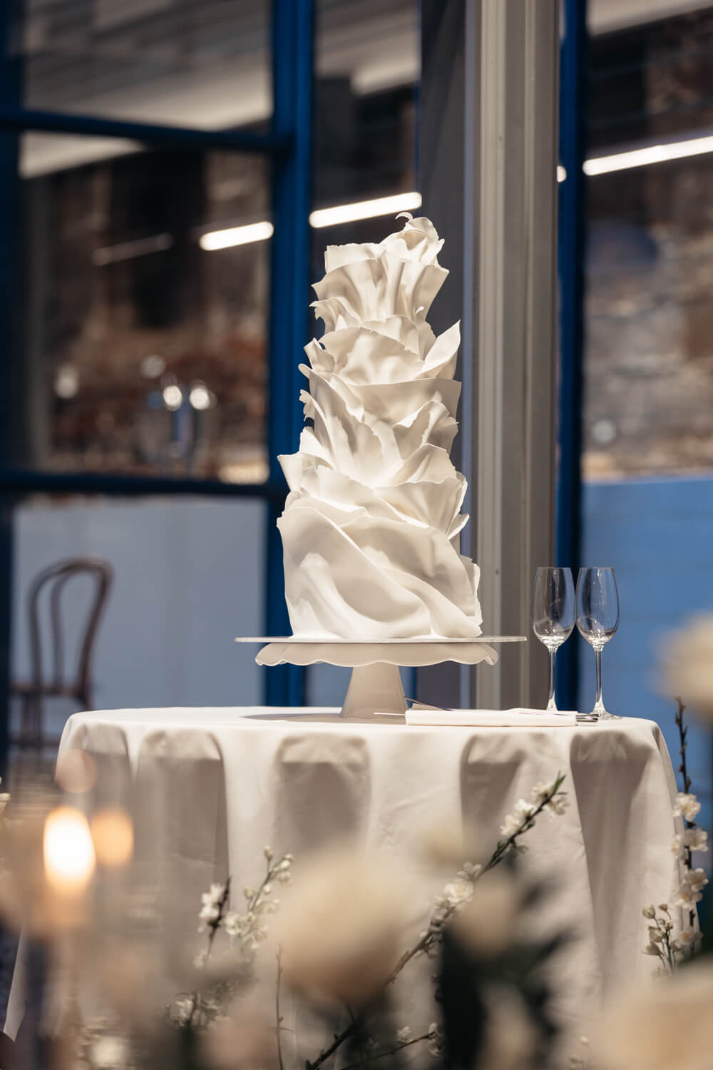 A stunning cake stands tall in the reception of this Sydney Mint wedding
