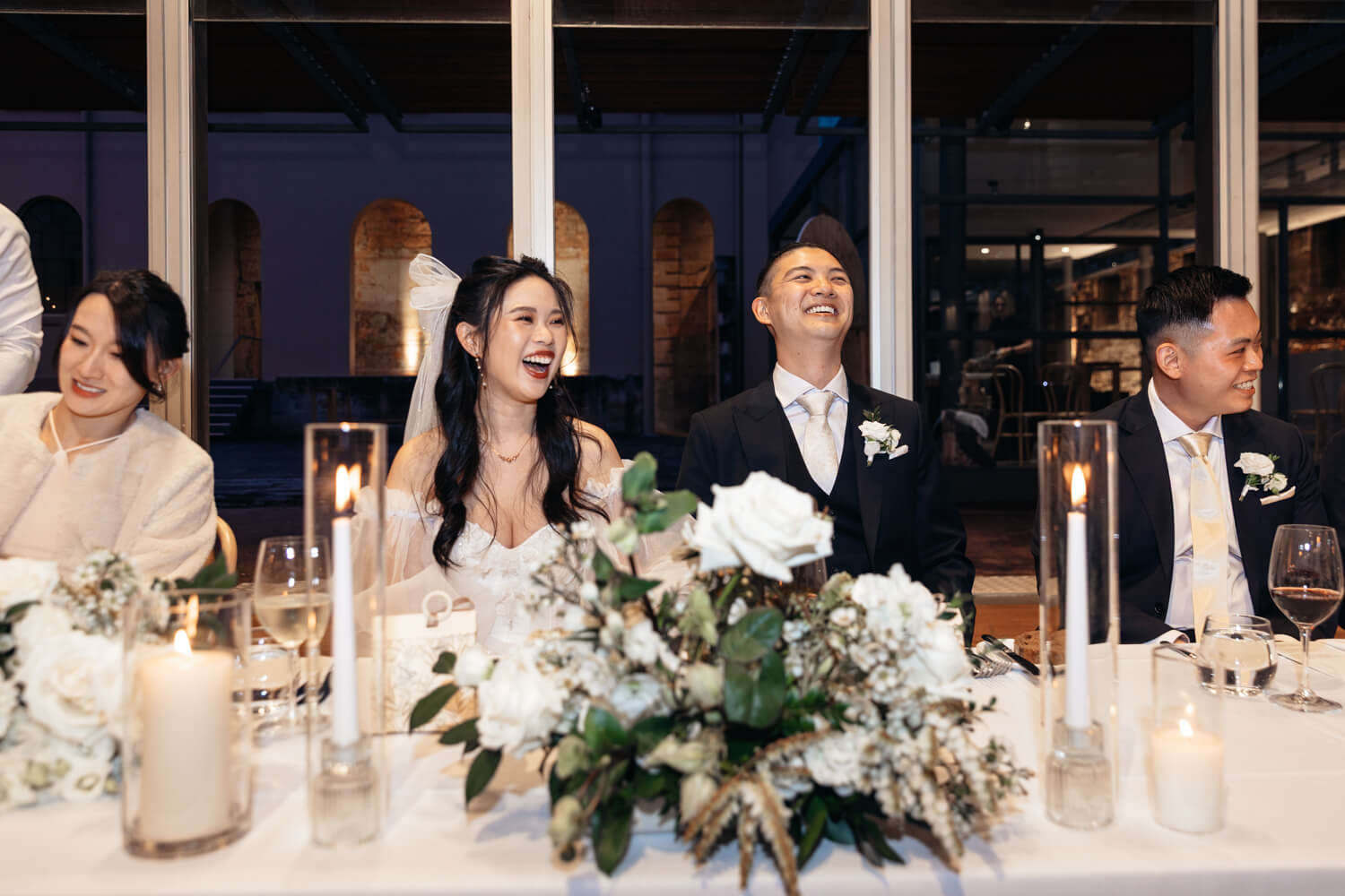 Bride and groom laughing during their wedding reception at The Mint