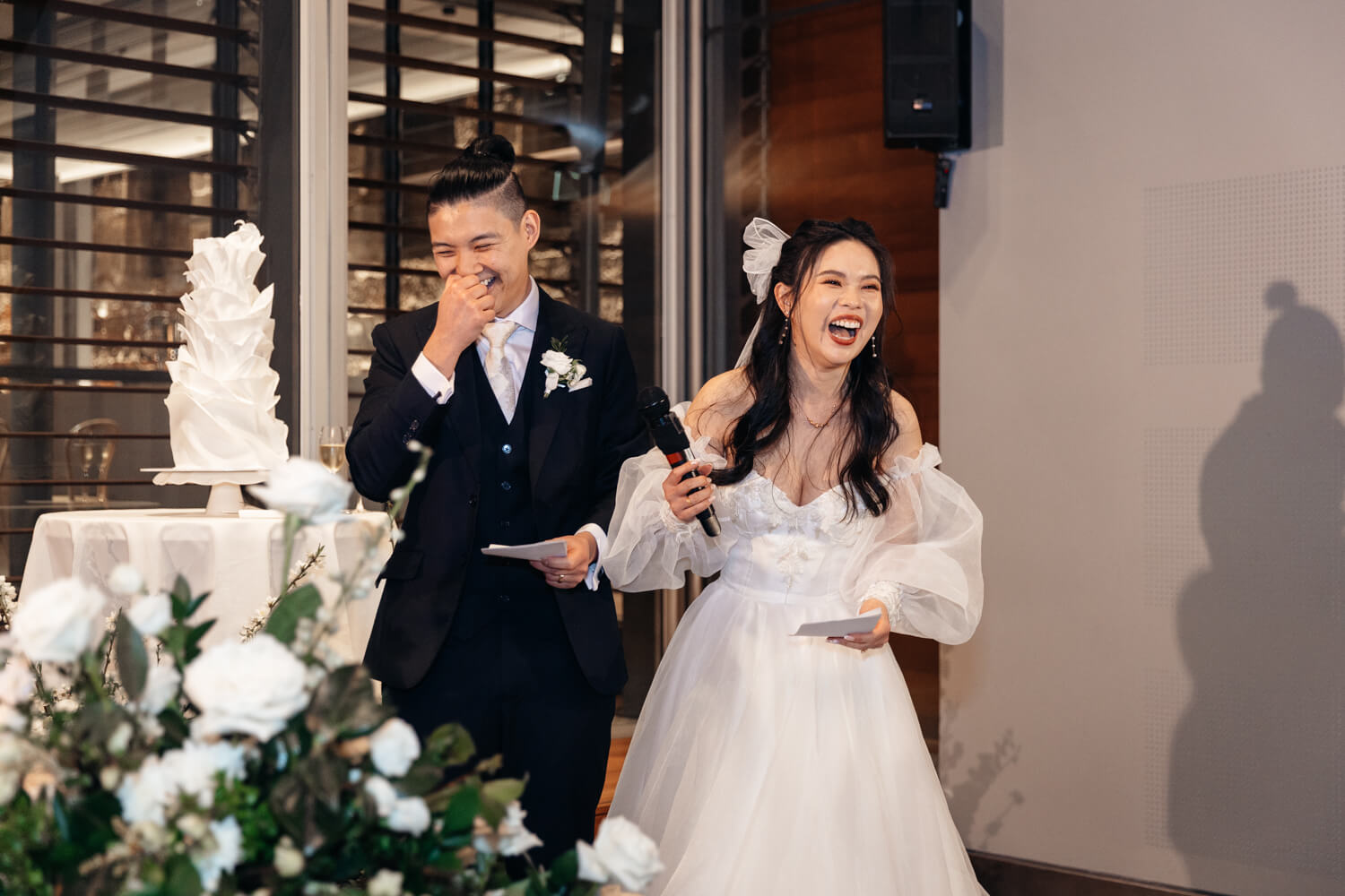 Bride and groom laughing during their wedding speech at The MInt