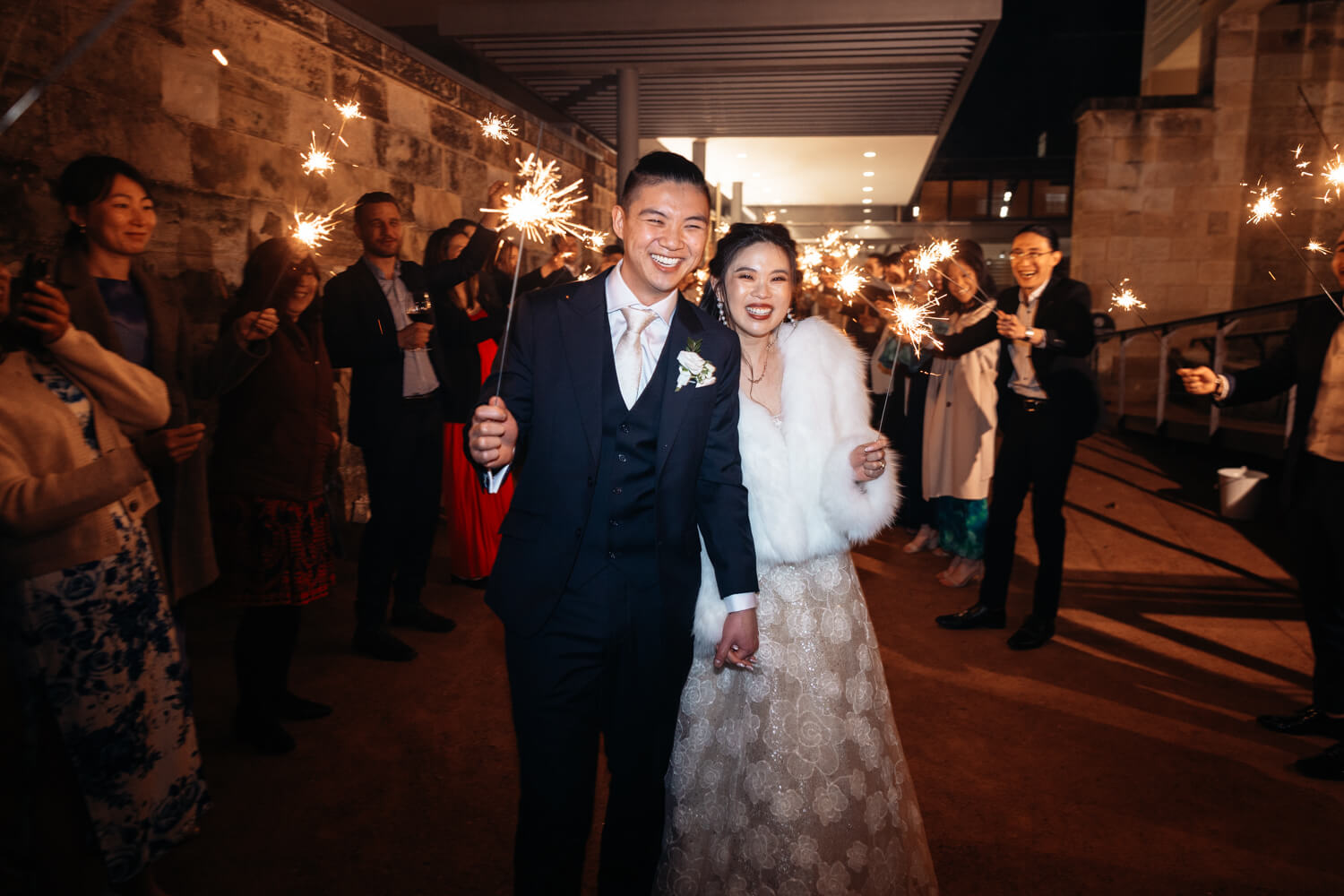 Bride and groom exiting the sparkler tunnel during their wedding at The Mint