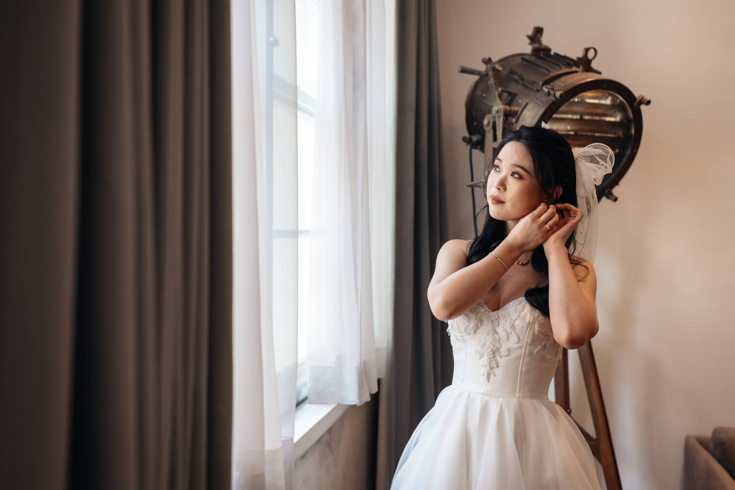 A bride fixing her earrings at The Old Clare Hotel in Sydney