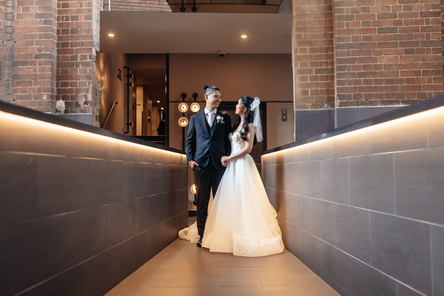 Bride and groom standing on the walkway at The Old Clare Hotel in Sydney on their wedding day