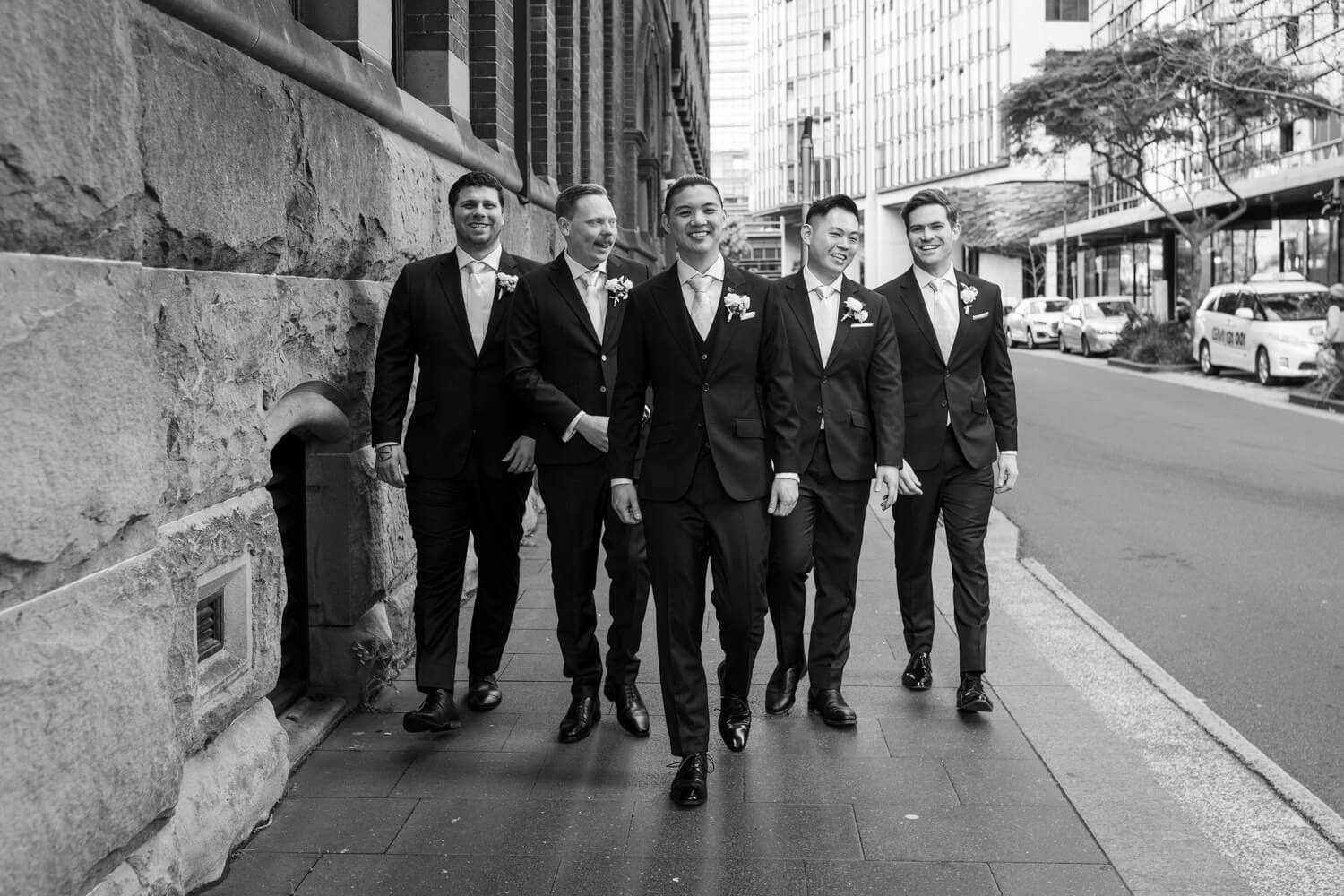 Groomsmen walking at The Old Clare Hotel on a wedding day