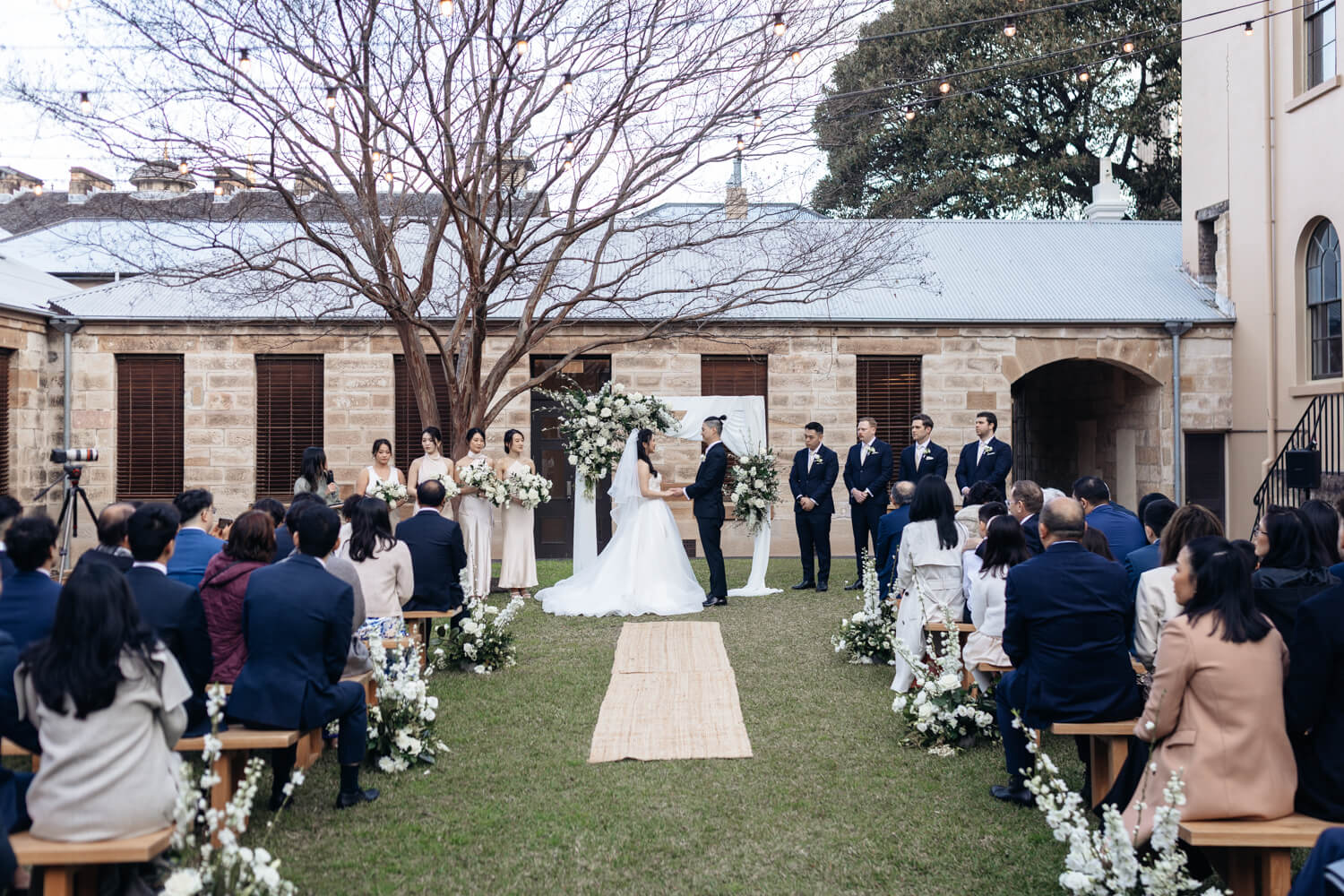 Bride and groom standing at the end of the aisle during their The Mint wedding